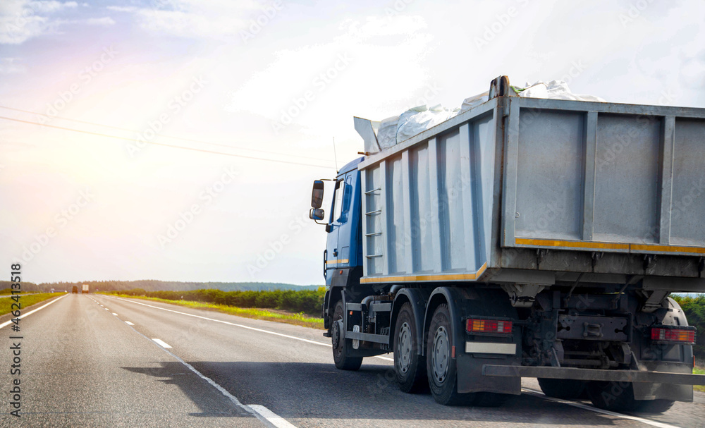 Transporting waste in a dump truck on the highway for recycling. Transportation of recyclable materials to a processing plant. Copy space for text, industry