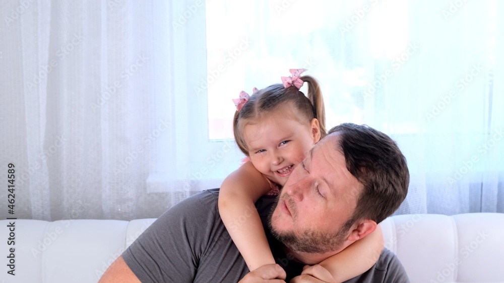 funny Little daughter 3 years old and father gently hug and have fun at home. have fun with your baby, fool concept. fathers day. parenting, relationships between children and parents funny Little daughter 3 years old and father gently hug and have fun at home. have fun with your baby, fool concept. fathers day. parenting, relationships between children and parents
