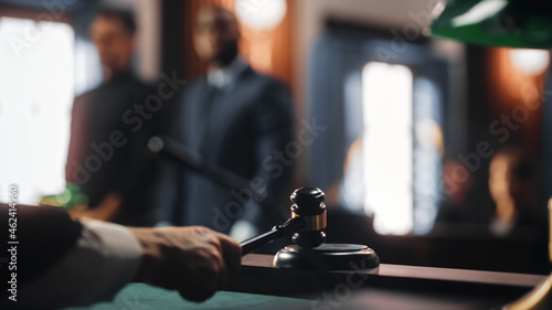 Cinematic Court of Law and Justice Trial: Judge Ruling Out a Positive Decision in a Civil Family Case, Close Up of a Striking Gavel to End Hearing. photo