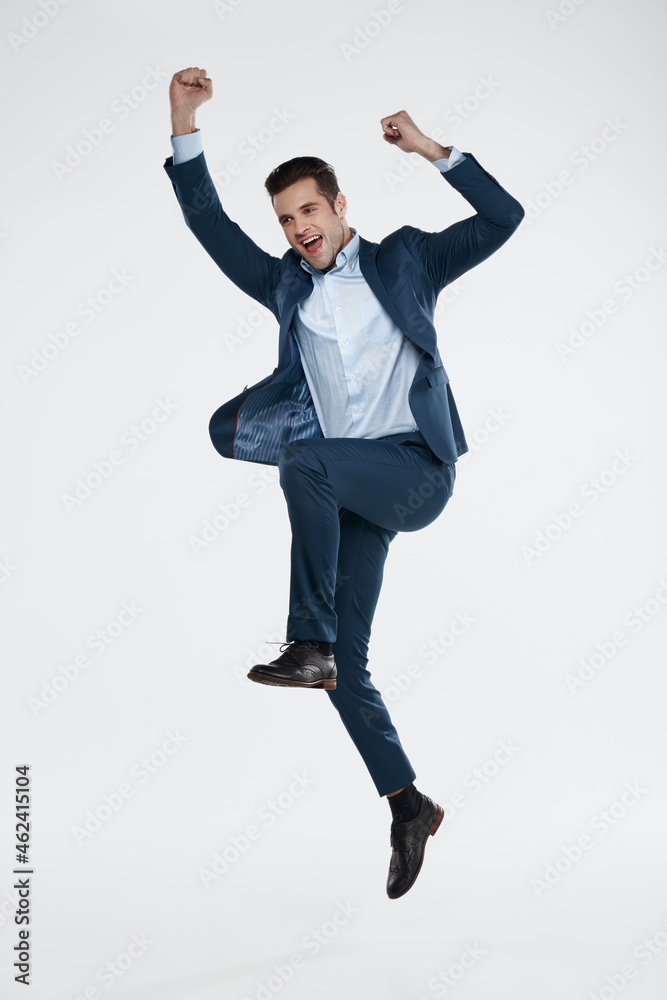 Young european business man enjoying and jumping