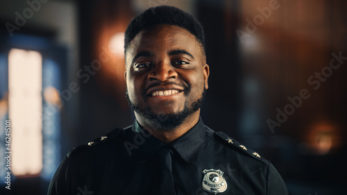 Billede på lærred Authentic Portrait of Happy and Handsome Black Policeman in Universal Uniform Smiling at Camera