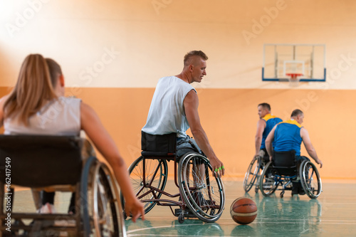 a photo of a war veteran playing basketball with a team in a modern sports arena. The concept of sport for people with disabilities