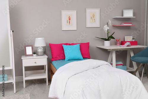 Modern teenager's room interior with comfortable bed and workplace © New Africa