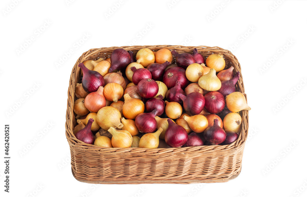 Multicolored yellow and red onions in a wicker basket on a white background, isolate, vegetable Multicolored yellow and red onions in a wicker basket on a white background, isolate, vegetable
