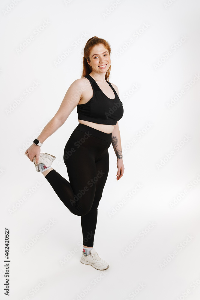 Smiling young plus size fitness woman in sportswear Smiling young plus size fitness woman in sportswear