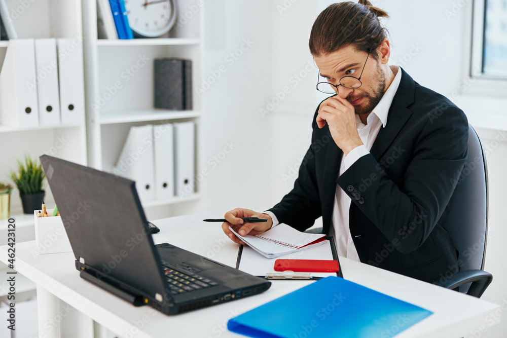 man in a suit documents work office laptop lifestyle man in a suit documents work office laptop lifestyle
