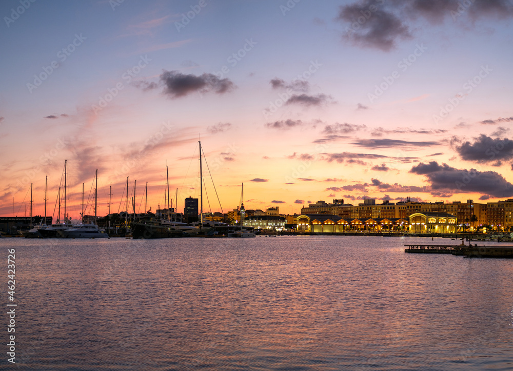 Old warehouse and Port Authority buildings Valencia harbor skyline, marina port nautical scenet sunset lights reflection in water Old warehouse and Port Authority buildings Valencia harbor skyline, marina port nautical scenet sunset lights reflection in water