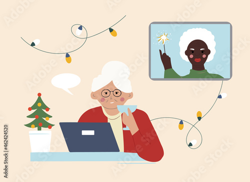 Two elderly grandmothers wish each other a Merry Christmas online. Communication over the Internet at a distance