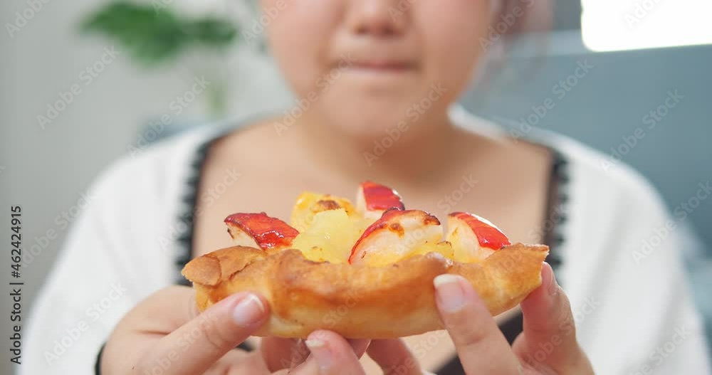 Close up mouth of plump Asian woman looking pizza with desire. Unhealthy eating - junk food concept. obese woman wants to lose weight and at the same time wants to eat. Close up mouth of plump Asian woman looking pizza with desire. Unhealthy eating - junk food concept. obese woman wants to lose weight and at the same time wants to eat.