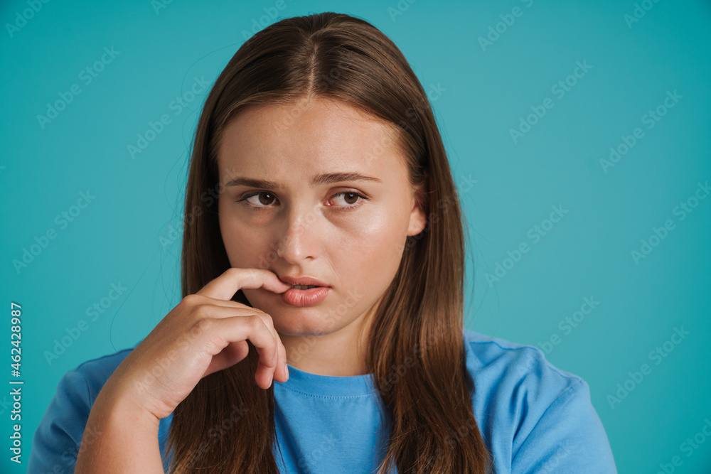 Young white woman wearing t-shirt frowning and looking aside Young white woman wearing t-shirt frowning and looking aside