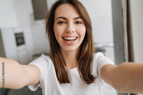 Smiling young woman in lounge wear standing