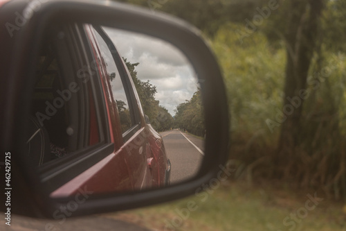 Road through car mirror