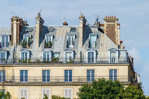 Typical architecture of Paris in France. The building roofs are curved and covered in zinc plates