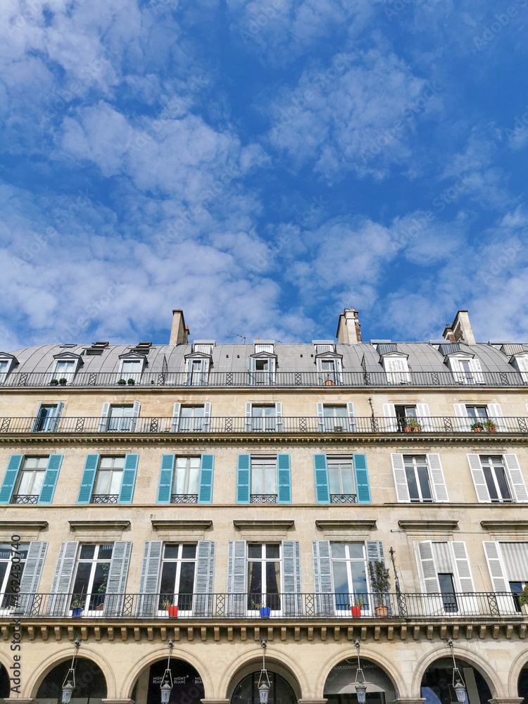 Typical architectural features of parisian buildings. Stone repetitive facade with blu zinc plates roof