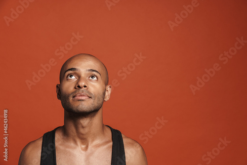 Black young man wearing shirt posing and looking upward