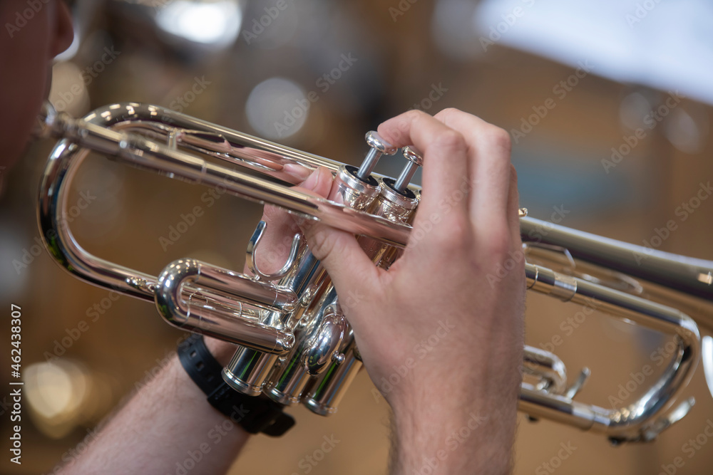 Obraz premium a small jazz band showing close ups of hands on brass instruments