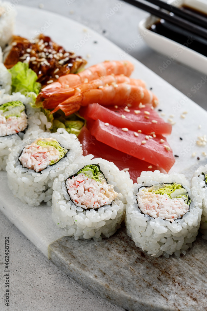 sushi on a plate served with shrimps and sashimi sushi on a plate served with shrimps and sashimi