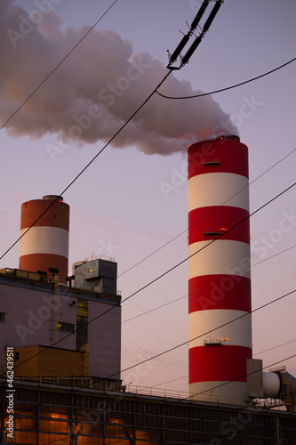 Close up for smoking chimney of the coal-fired power plant in Rybnik against the background of the evening sky. Photo taken during twilight under natural lighting conditions.