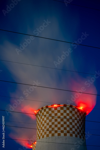 Evening picture of the coal-fired power plant. Blurry view for the steam coming out of the cooling towers. Photo taken in evening under natural lighting conditions.