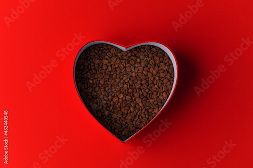 Coffee beans in a heart shaped box. coffee love concept, banner background.
