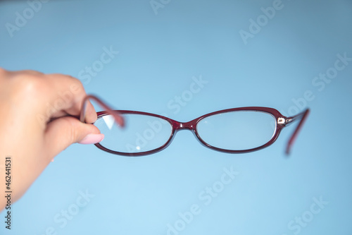 woman holding optic glasses