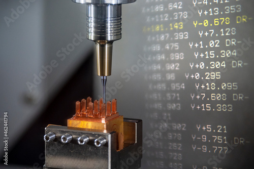 The abstract scene CNC milling machine cutting the  electrode parts with G-code data background.