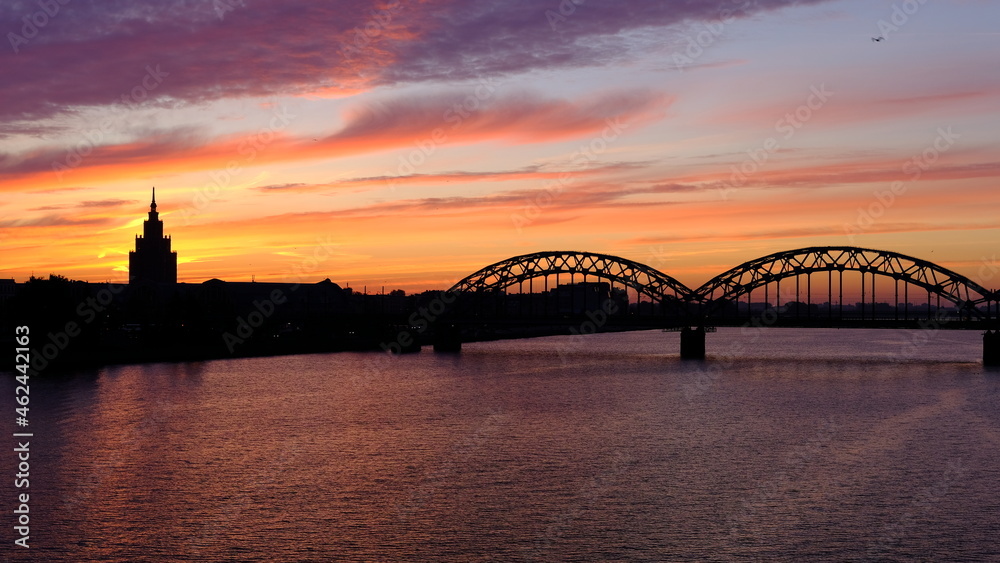 Naklejka premium Railway bridge in Riga against the background of dawn in autumn.