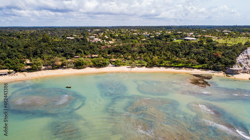 Fototapeta Naklejka Na Ścianę i Meble -  Praia de Curuípe, Porto Seguro, Bahia. Aerial view of Curuípe beach with reefs, corals and cliffs