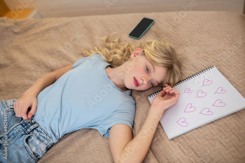 A cute blonde girl napping and looking peaceful
