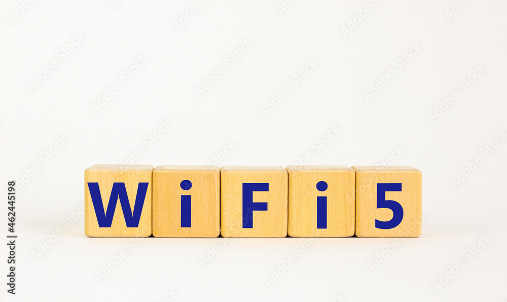 WiFi 5 symbol. The concept word WiFi 5 on wooden cubes. Beautiful white table, white background, copy space. Business, technology and WiFi 5 or WiFi5 concept.