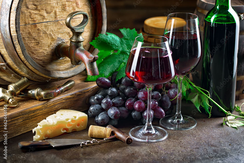 Wine glass with bottle and grapes on an old background.