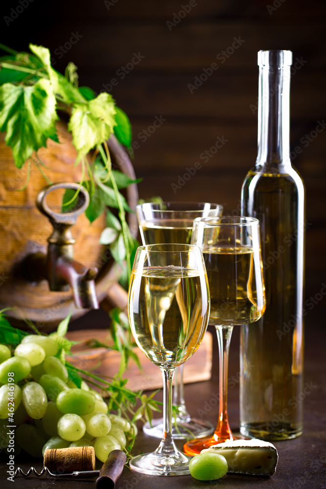 Wine glass with bottle and grapes on an old background.