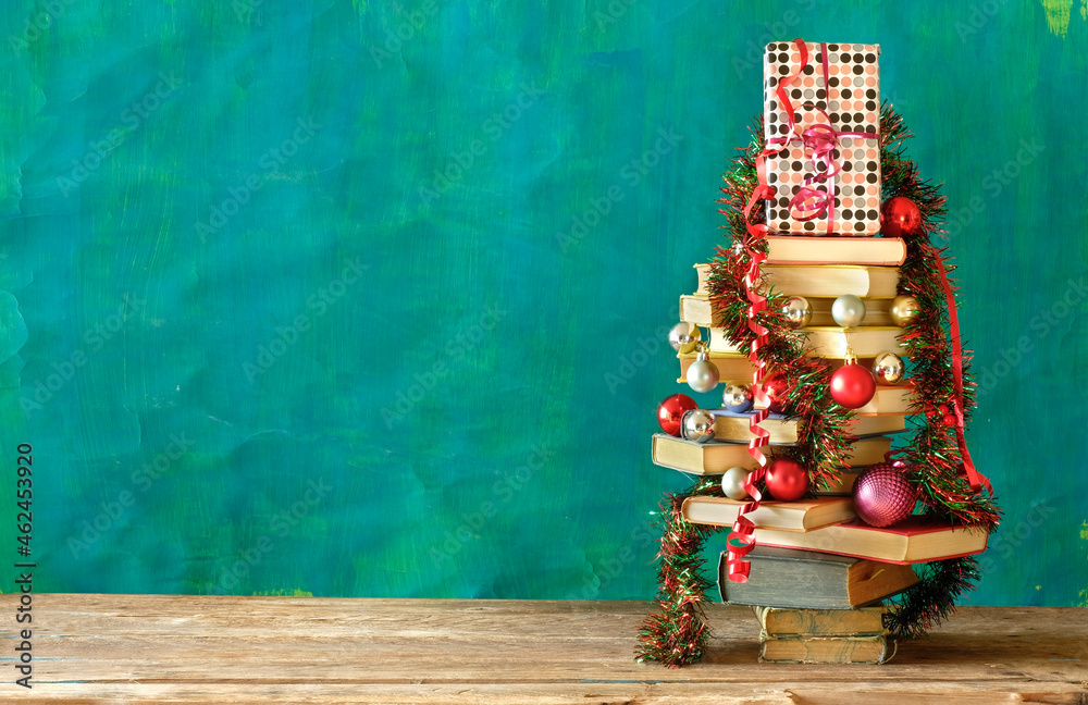 Giving books for christmas with christmas tree and decoration.Reading,literature,education,gift,present,christian holiday concept, copy space - obrazy, fototapety, plakaty 