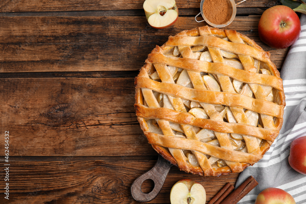 Delicious traditional apple pie on wooden table, flat lay. Space for text - obrazy, fototapety, plakaty 