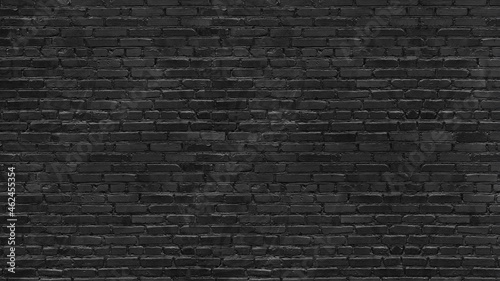 Old rough black brick wall large texture. Dark grey brickwork masonry backdrop. Gloomy grunge abstract background