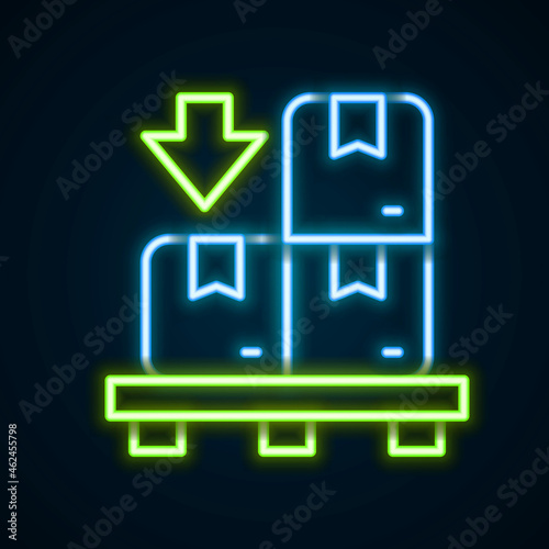 Glowing neon line Cardboard boxes on pallet icon isolated on black background. Closed carton delivery packaging box with fragile signs. Colorful outline concept. Vector