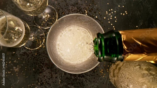 Super slow motion of pouring champagne into glass with camera motion. Filmed on high speed cinema camera, 1000 fps. photo