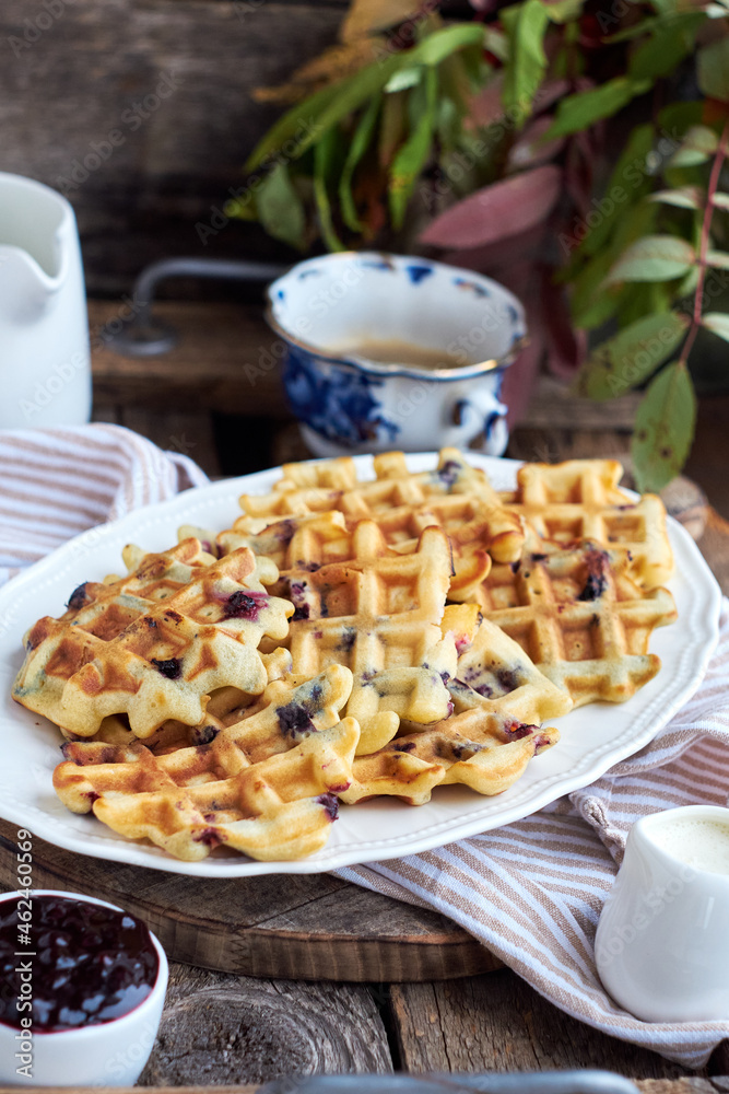 Belgian waffles blueberries. Side view, wooden background. Rustic. Belgian waffles blueberries. Side view, wooden background. Rustic.