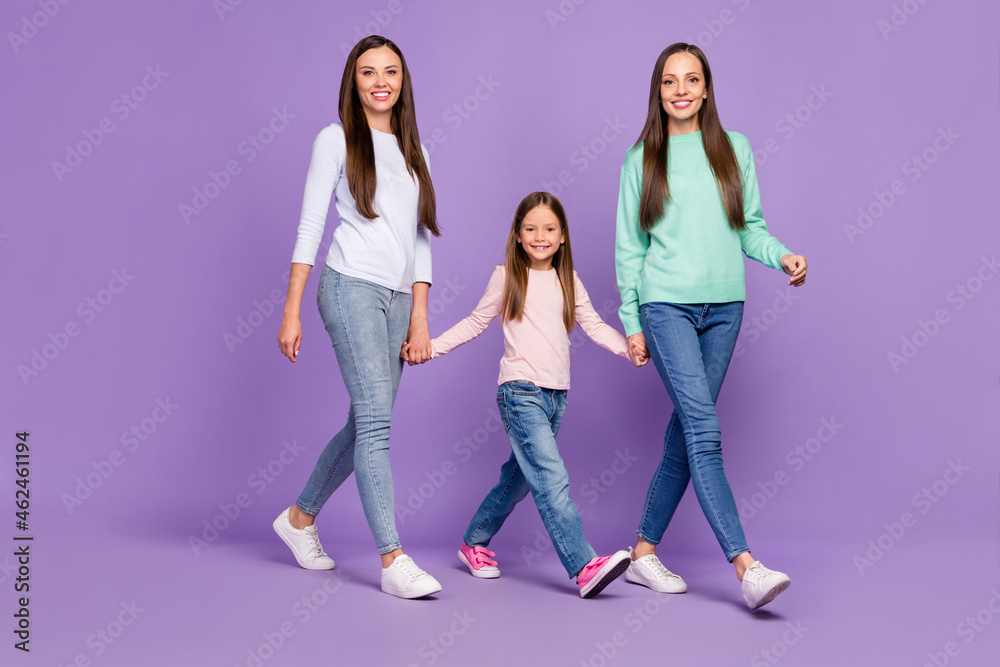 Fototapeta premium Full length body size profile side view of three lovely cheery girls going holding hands isolated over purple violet color background