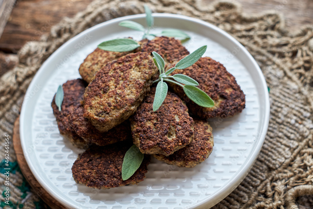 rissole on a wooden background decorated with sage. rissole on a wooden background decorated with sage.