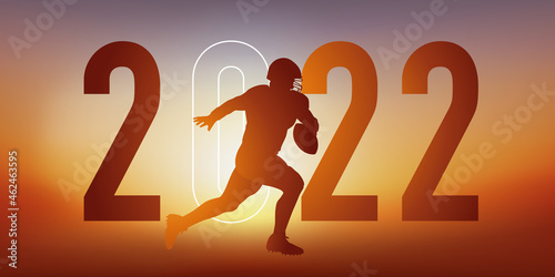 Concept du sport sur le thème du football américain pour une carte de vœux 2022, montrant un footballeur américain courant vers la ligne de but.