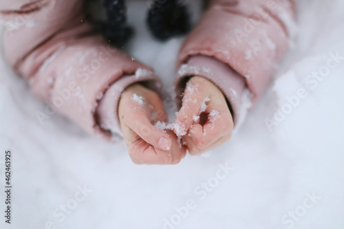 Children's hands in the snow close-up. photo