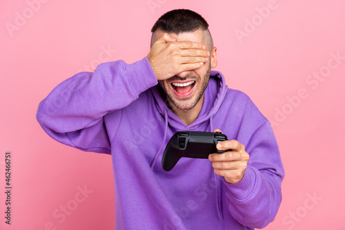 Photo of funny millennial brunet guy playstation wear violet hoodie isolated on pink background