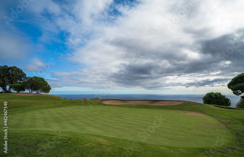 Green nr. 18 with clouds and see at Palheiro golf course on Madeira, Atlantic ocean, Portugal