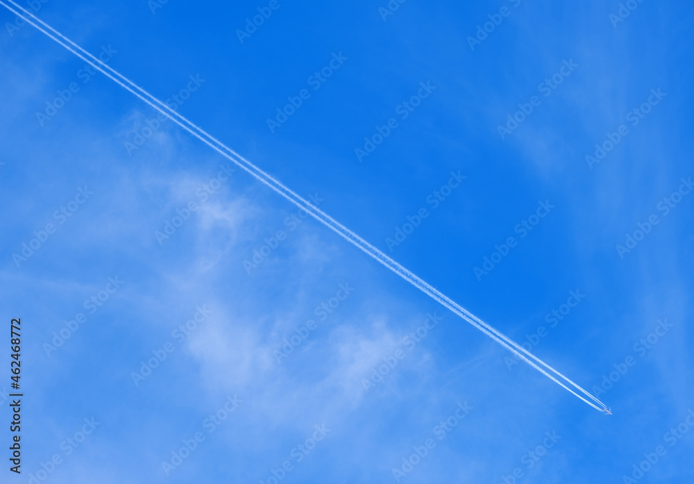 the plane against the blue sky and a long white trail behind it the plane against the blue sky and a long white trail behind it