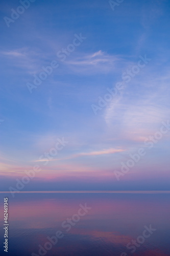 Sky background on sunset  colorful clouds. Nature abstract composition with reflections on sea water. Nature environment.