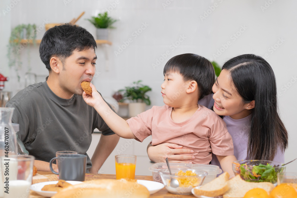 Happy refreshment family breakfast in morning, asian young parent father, mother and little cute boy, child having meal in kitchen eating together at home. Cheerful, enjoy cooking people. Happy refreshment family breakfast in morning, asian young parent father, mother and little cute boy, child having meal in kitchen eating together at home. Cheerful, enjoy cooking people.