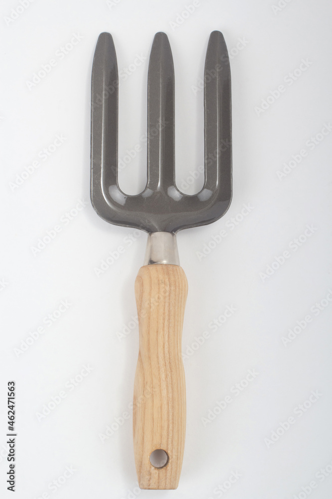 Small rake with wooden handle, gardening tool isolated on white background Small rake with wooden handle, gardening tool isolated on white background