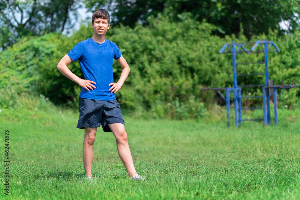 teenage boy exercising outdoors, sports ground in the yard, he posing at the horizontal bar, healthy lifestyle teenage boy exercising outdoors, sports ground in the yard, he posing at the horizontal bar, healthy lifestyle
