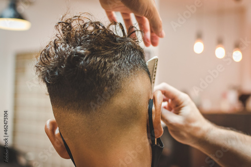 Hairdresser combing a client's hair after a trim